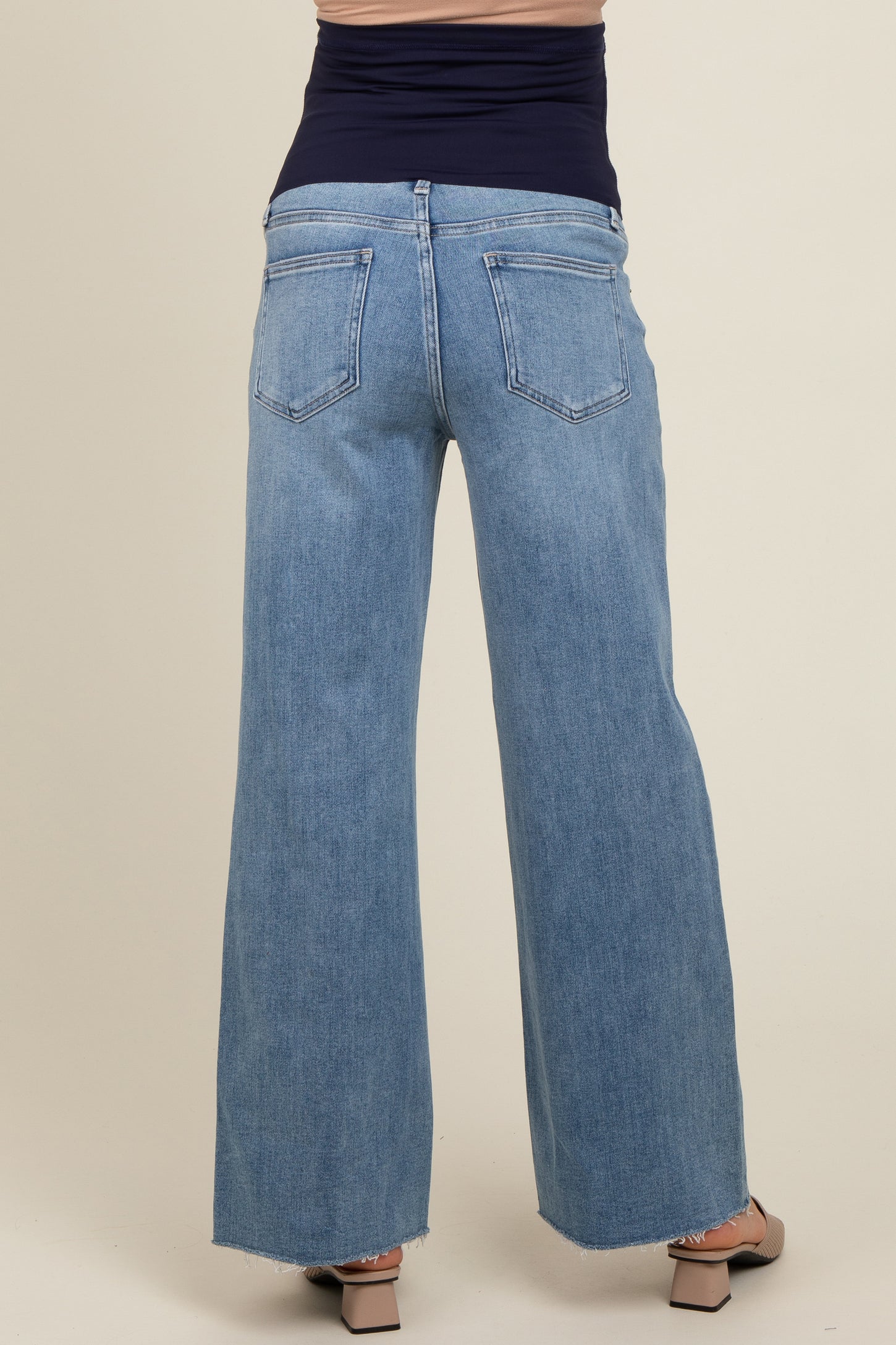woman wearing light blue wide leg maternity jeans, showing the back view