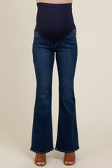 woman wearing dark blue maternity flared jeans with a supportive belly panel