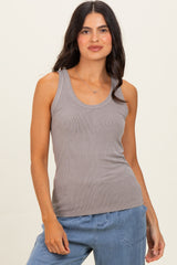 woman wearing a taupe ribbed tank top paired with light blue loose-fitting pants