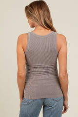 woman wearing a taupe ribbed maternity tank top, showing a fitted style from the back