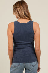 woman wearing a dark blue ribbed maternity tank top, showing the back view with no visible baby bump