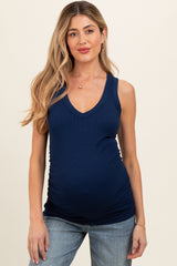 woman wearing a navy blue maternity tank top with a v-neck and showing her baby bump