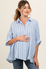 woman wearing a light blue striped maternity shirt and holding her baby bump