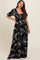 woman wearing a black floral printed maternity dress with puff sleeves and a square neckline, displaying her baby bump