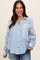 woman wearing a light blue striped maternity button-up shirt with a chest pocket and smiling at the camera