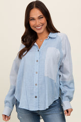 woman wearing a light blue button-up maternity shirt with striped pattern and long sleeves, smiling at the camera