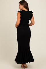 woman wearing a black ribbed maternity dress with ruffle sleeves and a flared hem from the back