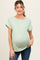 woman wearing a mint green short sleeve maternity top with rolled sleeves and a visible baby bump