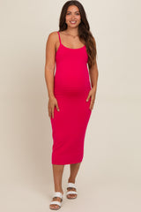 woman wearing a bright pink striped maternity midi dress and showing her baby bump