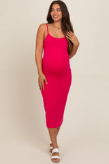 woman wearing a bright pink ribbed maternity dress, showcasing her baby bump, with spaghetti straps and a midi length
