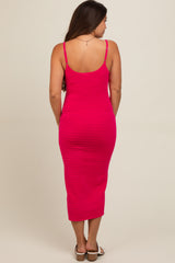 woman wearing a hot pink ribbed maternity dress with a fitted silhouette, showing a baby bump from the back