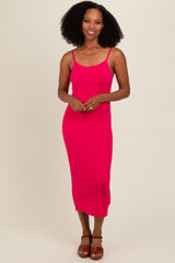woman wearing a bright pink ribbed midi dress with thin straps and a fitted silhouette