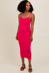 woman wearing a hot pink ribbed midi dress with thin straps and a fitted silhouette
