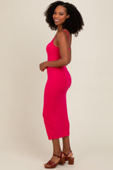 woman wearing a fitted hot pink midi dress with a ribbed texture and spaghetti straps, standing sideways