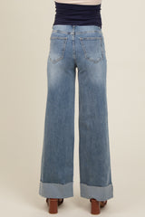 woman wearing light blue wide-leg maternity jeans with a frayed hem, viewed from the back
