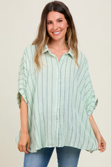woman wearing a light green striped maternity shirt with a relaxed fit and short sleeves