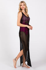 woman wearing a black crochet cover-up dress with a pink bikini underneath, showcasing side slits and a flowy silhouette