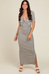 woman wearing a black and white striped midi dress with a twisted front and side slit