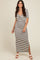 woman wearing a black and white striped midi dress with a twisted front and side slit