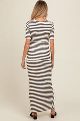 woman wearing a black and white striped maternity maxi dress from the back