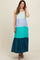 woman wearing a multi-colored maternity maxi dress with blue and green tiers and a flowy bottom