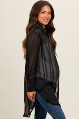 woman wearing a black striped maternity button-up shirt with long sleeves and a baby bump visible