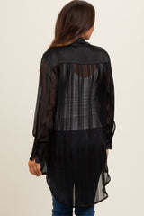 woman wearing a black sheer maternity top with a long back and striped pattern