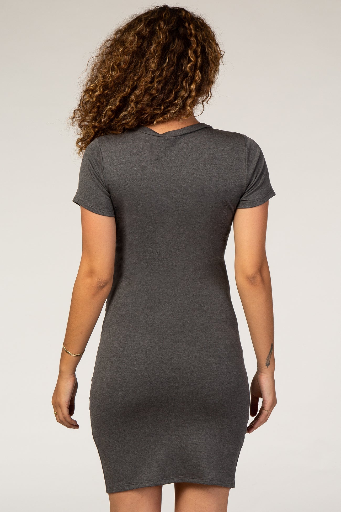 woman wearing a charcoal gray short sleeve maternity dress, viewed from the back