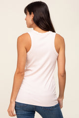 back view of a woman wearing a light pink ribbed racerback tank top and blue jeans
